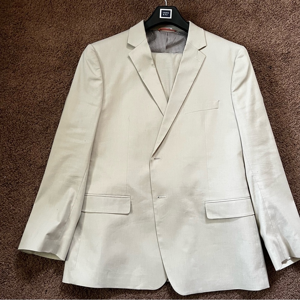 tan crown and Ivy  suit.